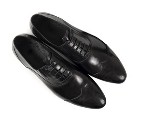 Top view of classic black leather shoes on white