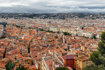 Fototapeta na wymiar Nice old town, French Riviera, France. View of the city with red roofs, colorful houses and narrow streets from above. Travel Europe.