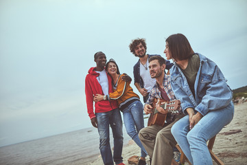 Indie music. Group of happy friends having good holiday experience while spending time together at...