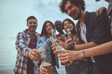 Celebrating holiday. Group of people drinking alcohol during their day off and smiling
