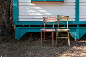 Chairs in front of a bungalow