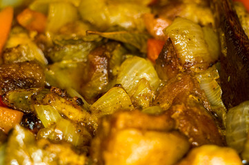 Roast meat, onions, carrots and spices, boiling in oil