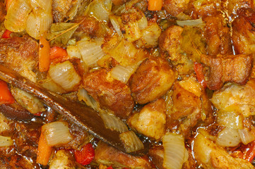Roast meat, onions, carrots and spices, boiling in oil