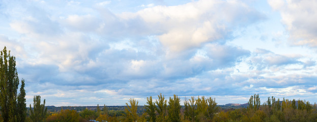 Landscape with dramatic light - beautiful golden sunset with saturated sky and clouds.