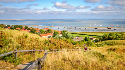 Looking across the Wadden Sea from the Frisian Island of Vlieland during sunset on a summer night. The Frisian Islands are also known as the Wadden Islands or Wadden Sea Islands