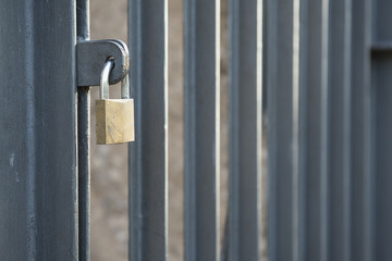 Closed padlock on a Closed gate with vertical bars