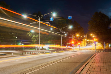  The night road in the city with lights and light trails of traffic.