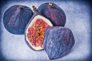 a few figs with cut in half in rustic coloring like autumn fruit 