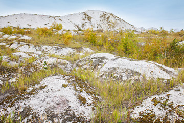 Landscape with white mountains and hills. Amazing abandoned desert view. Phosphogypsum stack of chemical production wastes. Autumn view