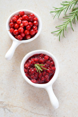 Cowberry sauce with rosemary and coconut sugar. Cranberry confiture. Spicy berry jam to meat, turkey. Autoimmune Paleo. Diet healthy food concept. Cereals Gluten Dairy free. Copy space.