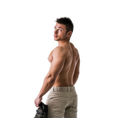 Fototapeta premium Cute muscular ripped young bodybuilder turning to look at camera. Isolated on white background in studio