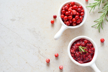 Cowberry sauce with rosemary and coconut sugar. Cranberry confiture. Spicy berry jam to meat,...