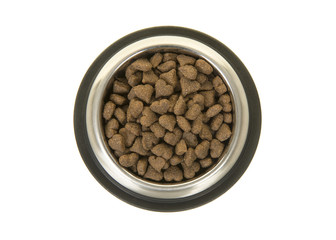 Round metal feeding bowl with heart shaped pet kibble seen from above isolated on a white background