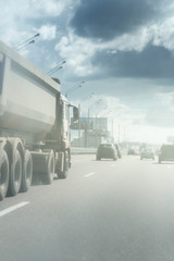 dump truck on highway in sunny day and clouds