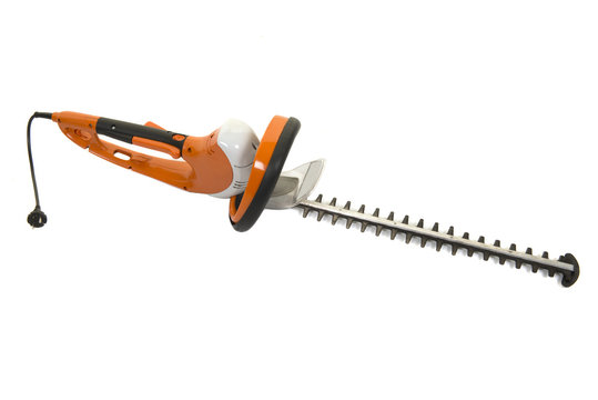 Orange used electric hedge trimmer isolated on a white background