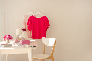 Workplace for sewing and needlework in a bright room with white furniture.