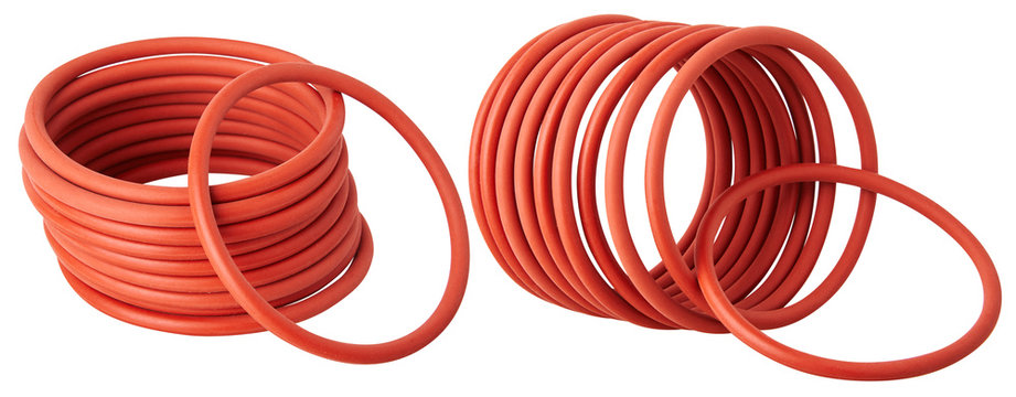 Set of orange hydraulic and pneumatic o-ring seals isolated on a white background. Rubber rings. Sealing gaskets for hydraulic joints. Rubber sealing rings for plumbing. 