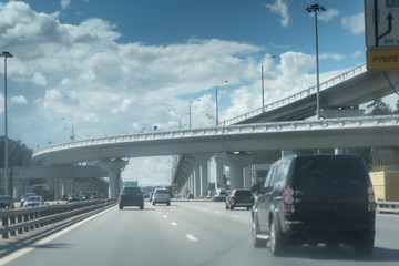 New Riga highway. Elevated roads on cloudy day. City traffic with a lot of cars.