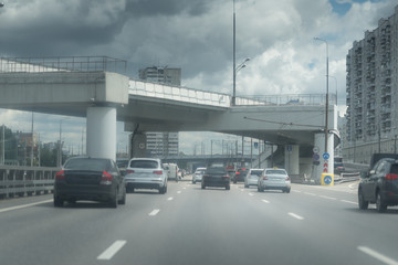 New Riga highway. Elevated roads on cloudy day. City traffic with a lot of cars.