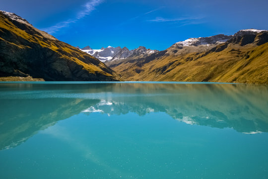 Reflections on the water reservoir of the Lac de Moiry (Valais, Switzerland). It is part of a gravity dam or barrage in the Valley of Grimentz.