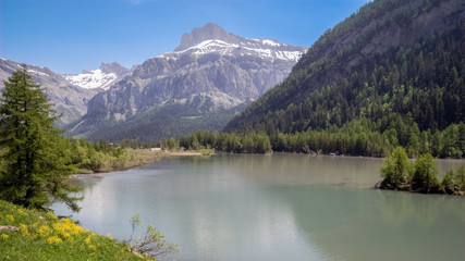 Naklejka na ściany i meble The Lac de Derborence in the canton of Valais, in Switzerland. It is located at 1,450 metres in an isolated valley and is not permanently inhabited. Derborence is completely surrounded by mountains.