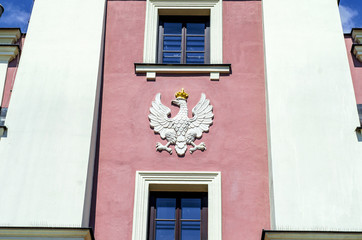 Ancient coat of arms, an eagle, on the wall of the Town Hall in the city