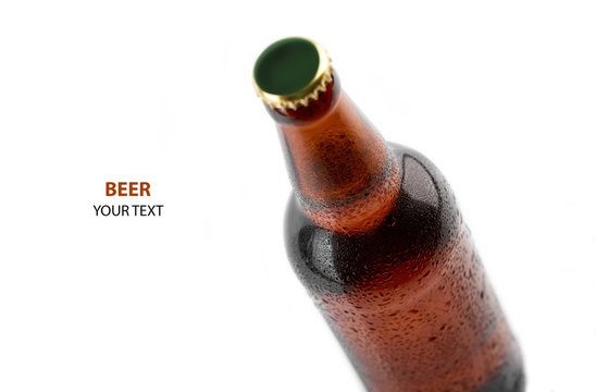 Studio photo of isolated bottle of beer on white background. Cold bottle of beer with condensate water drops on it. Beer bottle with water drops isolated on white