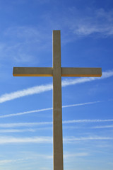 religion wooden cross against the blue sky.