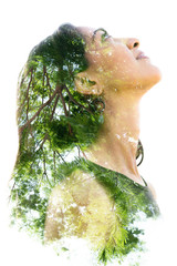 Double exposure portrait of a naturally beautiful happy woman and a tree with bright green leaves
