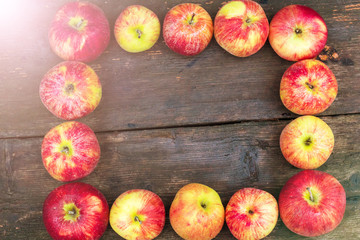 Apples on wooden table background. Fresh fruit backdrop with empty space for text