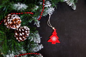 Christmas or New Year dark wooden background, Xmas black board framed with season decorations, space for a text, view from above