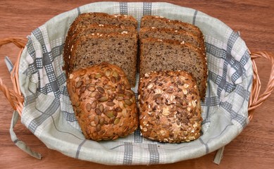 Buns and bread with seeds in a wicker basket