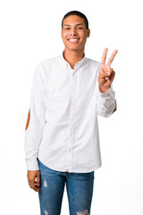 Young african american man with white shirt happy and counting two with fingers on isolated white background