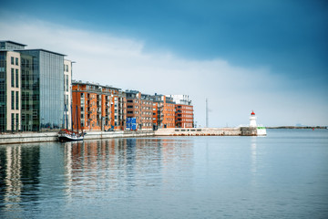 Naklejka premium Cityscape of harbour and lighthouse in Malmo, Sweden, modern city urban landscape