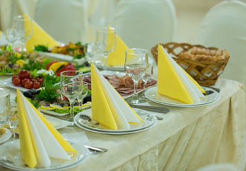 banquet hall of the restaurant, beautifully decorated tables with food	