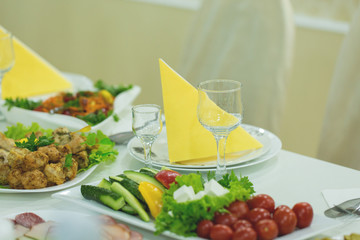banquet hall of the restaurant, beautifully decorated tables with food	