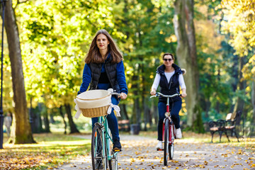 Healthy lifestyle - people riding bicycles in city park