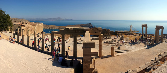 Lindos, Rhodes, Greece - September 4, 2018: Tourists visit the ruins of the Acropolis.