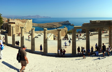 Lindos, Rhodes, Greece - September 4, 2018: Tourists visit the ruins of the Acropolis.