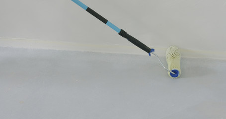 closeup applying primer on the floor