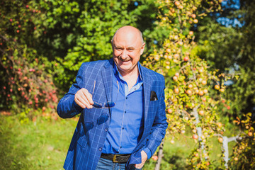Mature European or American man with a good mood, outdoor portrait. The concept of life after 50-60...