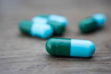 drug capsule antibiotic on wood table background