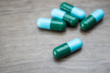 drug capsule antibiotic on wood table background