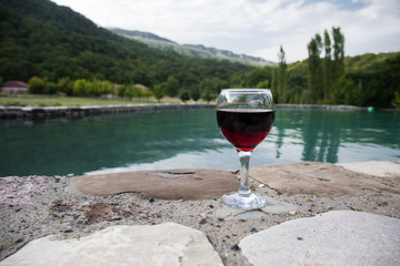 Drink in tall glass in poolside. Refreshment on summer day. Purple juice cocktail or vine.