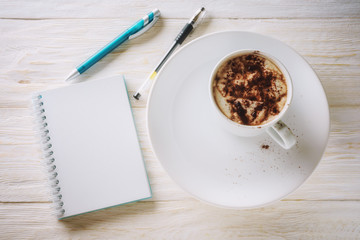 Sketchpad and cup of hot cocoa