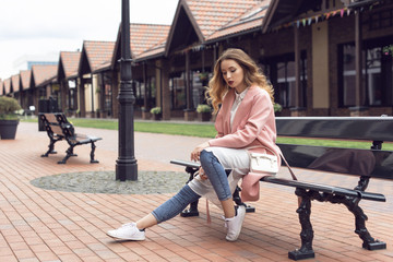 A girl is walking in the autumn in a European city