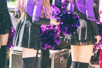 Cheerleaders in purple suits