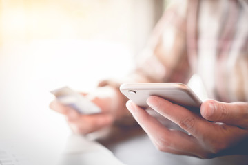 Close up hand of woman using smart phone for online shopping at home. Online shopping concept
