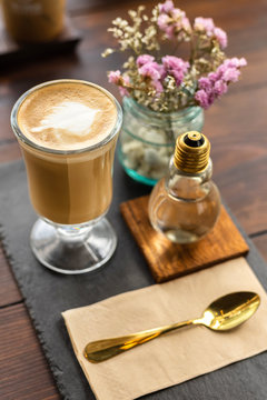 Hot Coffee With Syrup And Gold Spoon On Wood Table