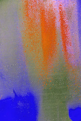 Colorful spray paint splatters on the wall